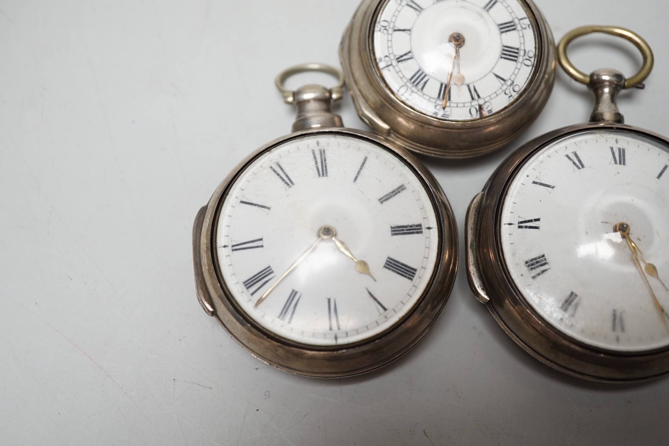 An 18th century silver pair cased keywind verge pocket watch, by Sam Toulmin, London, a similar watch by Tomlin, London and one other silver pair cased pocket watch with unsigned movement.